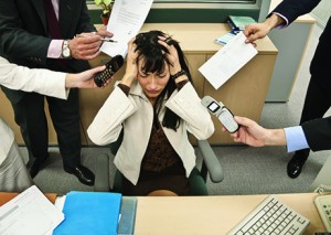 Business people bothering stressed businesswoman
